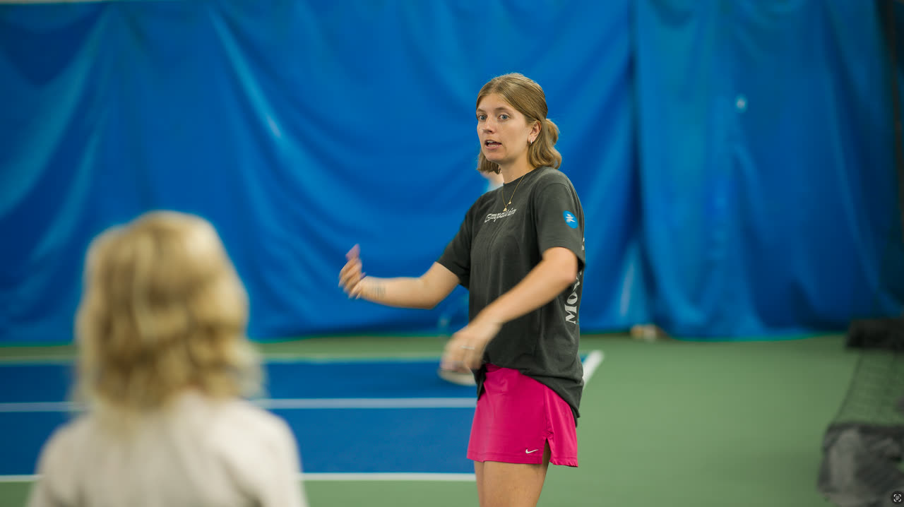 A coach walking a player through a drill at Match Point KC