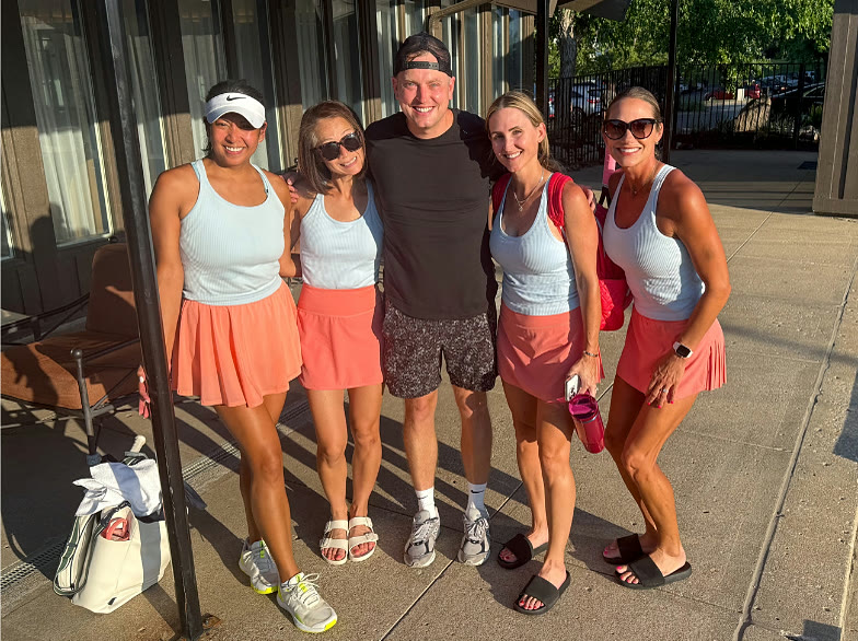 Will Gross with four women players in matching tennis skirts